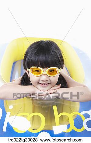 Stock Photo - girl is lying face down on the boat. Fotosearch