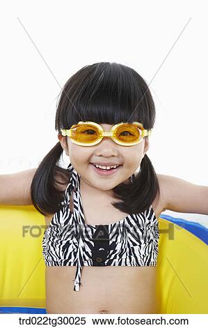 Stock Photography - girl is sitting on boat with swim goggles. Fotosearch