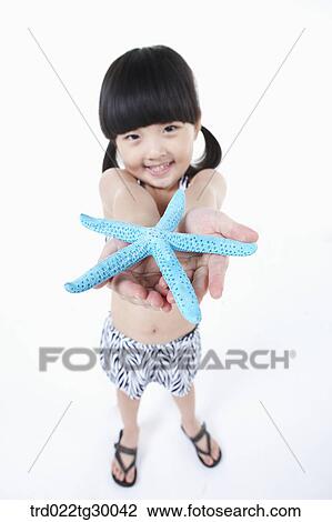 girl stretched her arms out with starfish View Large Photo Image Stock Image - girl stretched her arms out with starfish. Fotosearch