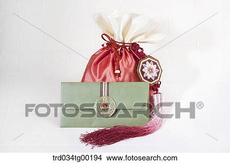 Picture - Green envelope and red lucky bag. Fotosearch