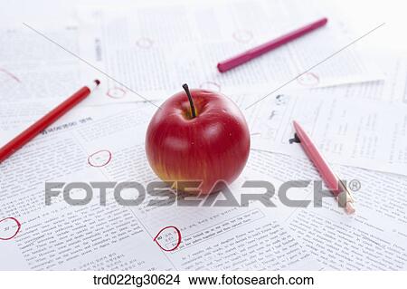Picture - Marked Test Papers With Color Pencils And An Apple. Fotosearch