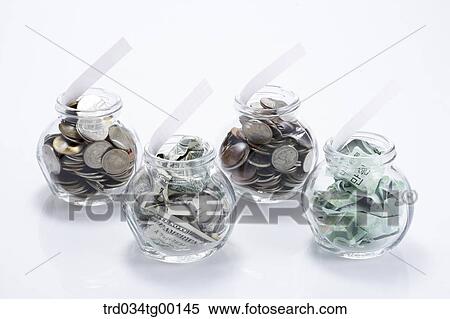 money bills and coins in glass bottle View Large Photo Image Stock Photography - money bills and coins in glass bottle. Fotosearch
