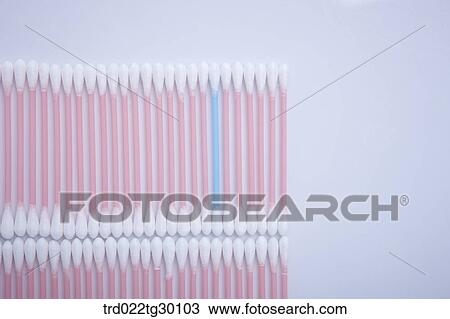 Stock Image - One blue cotton swab and other white cotton swab in a row. Fotosearch