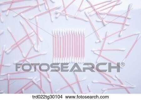 Picture - Organized white cotton swab with scattered other ones around. Fotosearch