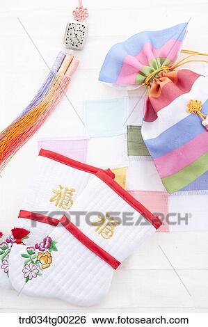 Stock Photograph - Patched colorful lucky bags, traditional socks, and clothes accessory. Fotosearch