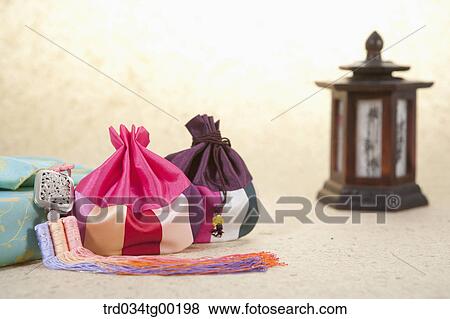 Patched lucky bags and blue wrapped package with traditional lamp View Large Photo Image Stock Photo - Patched lucky bags and blue wrapped package with traditional lamp . Fotosearch
