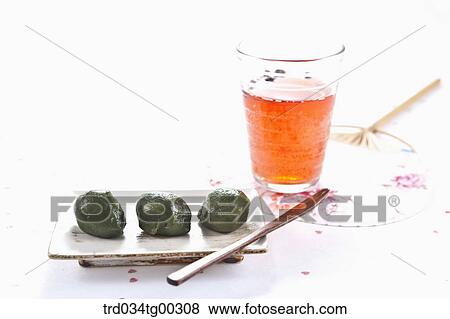 Stock Photo - Rice cake, a glass of drink, and a fan . Fotosearch