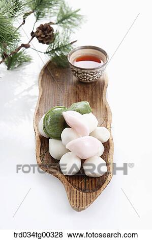 Stock Photo - Rice cake and a cup of tea with pine branch . Fotosearch