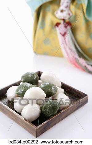 Rice cake with traditional wrapped package behind View Large Photo Image Stock Image - Rice cake with traditional wrapped package behind. Fotosearch