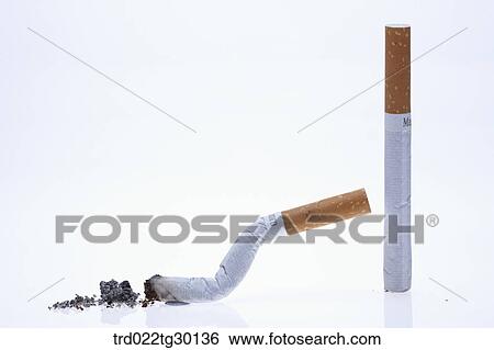 Stacked cigarettes with other scatted cigarettes around View Large Photo Image Stock Photograph - Stacked cigarettes with other scatted cigarettes around. Fotosearch