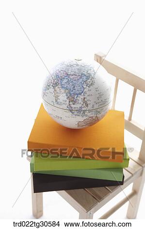 Picture - Various Colors Of Books And A Globe On Wooden Chair. Fotosearch