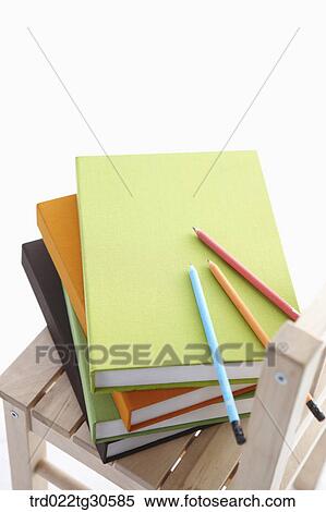 Stock Photography - Various Colors Of Books And Pencils On Wooden Chair. Fotosearch