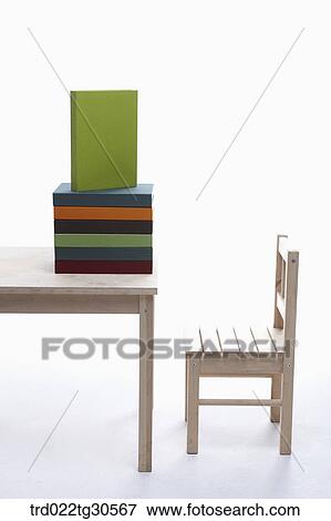 Various Colors Of Books On Wooden Desk And Chair View Large Photo Image Stock Photo - Various Colors Of Books On Wooden Desk And Chair. Fotosearch
