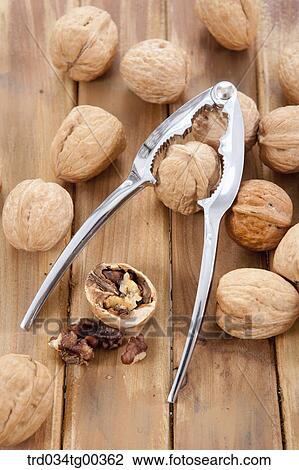 Walnuts And A Nutcracker And A Cracked Walnut View Large Photo Image Stock Image - Walnuts And A Nutcracker And A Cracked Walnut. Fotosearch