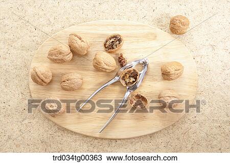 Walnuts And A Nutcracker And Cracked Walnut On Wooden Board View Large Photo Image Stock Image - Walnuts And A Nutcracker And Cracked Walnut On Wooden Board. Fotosearch