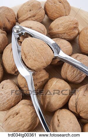 Stock Image - Walnuts And A Nutcracker. Fotosearch