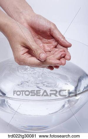 Stock Image - washing hand in basin. Fotosearch