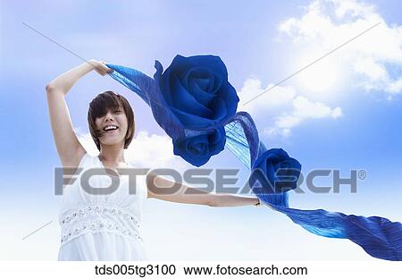 Woman With Blue Roses On Blue Scarf Flying In Breeze View Large Photo Image Stock Image - Woman With Blue Roses On Blue Scarf Flying In Breeze. Fotosearch