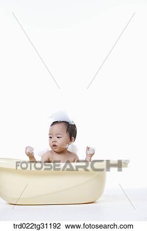 A baby looking at the bubble in the bathtub View Large Photo Image Stock Image - A baby looking at the bubble in the bathtub. Fotosearch