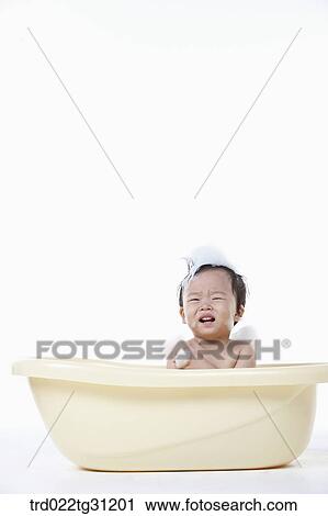 A baby taking a bath in the bathtub with the bubble on his body View Large Photo Image Stock Image - A baby taking a bath in the bathtub with the bubble on his body. Fotosearch