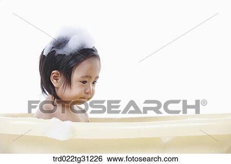 A baby taking a bath in the bathtub with the bubble on her body View Large Photo Image Stock Photograph - A baby taking a bath in the bathtub with the bubble on her body. Fotosearch