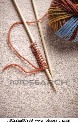A ball of colorful wool with a pair of knitting needle View Large Photo Image Stock Photo - A ball of colorful wool with a pair of knitting needle . Fotosearch