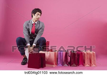 A bored man with many shopping bags around View Large Photo Image Stock Image - A bored man with many shopping bags around. Fotosearch