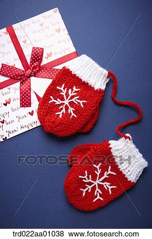 A card with red ribbon and a pair of red gloves View Large Photo Image Stock Photo - A card with red ribbon and a pair of red gloves. Fotosearch