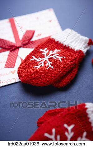 Stock Photograph - A card with red ribbon and a pair of red gloves. Fotosearch