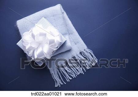 A gift box with white ribbon and a blue knit muffler View Large Photo Image Stock Image - A gift box with white ribbon and a blue knit muffler . Fotosearch