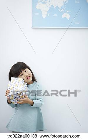 A girl having her face on a gift with the world map View Large Photo Image Stock Photo - A girl having her face on a gift with the world map . Fotosearch