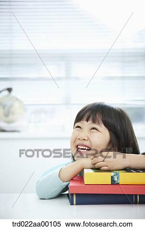 A girl having her hands on the pile of books View Large Photo Image Stock Photography - A girl having her hands on the pile of books. Fotosearch
