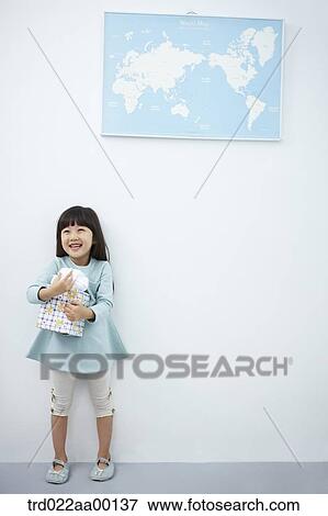 A girl hugging a gift with the world map View Large Photo Image Stock Photo - A girl hugging a gift with the world map . Fotosearch