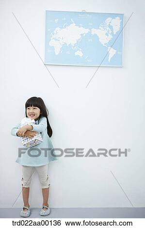 A girl hugging a gift with the world map View Large Photo Image Stock Photograph - A girl hugging a gift with the world map . Fotosearch