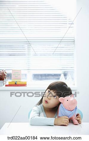 A girl with a pink piggy bank on her face View Large Photo Image Picture - A girl with a pink piggy bank on her face. Fotosearch