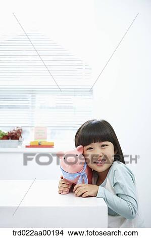 A girl with a pink piggy bank on her face View Large Photo Image Picture - A girl with a pink piggy bank on her face. Fotosearch