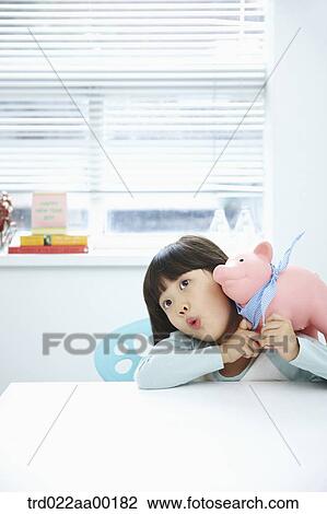 A girl with a pink piggy bank on her face View Large Photo Image Stock Image - A girl with a pink piggy bank on her face. Fotosearch