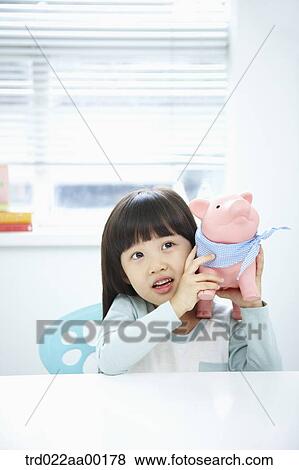 A girl with a pink piggy bank on her face View Large Photo Image Stock Photo - A girl with a pink piggy bank on her face. Fotosearch