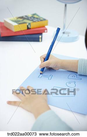 A girl writing 'I'm happy' on the blue paper with a blue colored pencil View Large Photo Image Stock Image - A girl writing 'I'm happy' on the blue paper with a blue colored pencil. Fotosearch