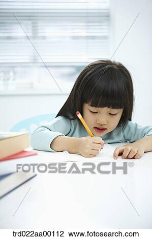 A girl writing on a notebook with a pencil View Large Photo Image Stock Image - A girl writing on a notebook with a pencil . Fotosearch