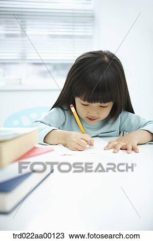 A girl writing on a notebook with a pencil View Large Photo Image Stock Image - A girl writing on a notebook with a pencil . Fotosearch