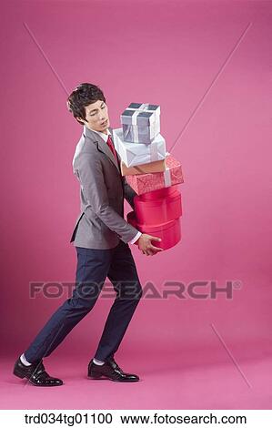 A man holding the many gift boxes View Large Photo Image Stock Image - A man holding the many gift boxes. Fotosearch