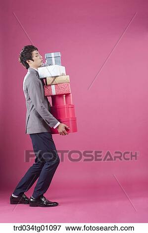 A man holding the many gift boxes View Large Photo Image Stock Photo - A man holding the many gift boxes. Fotosearch