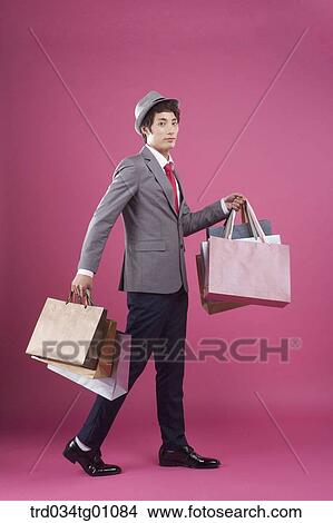 A man holding the many shopping bags View Large Photo Image Picture - A man holding the many shopping bags. Fotosearch