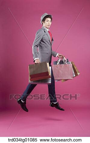 A man jumping with the many shopping bags View Large Photo Image Stock Photography - A man jumping with the many shopping bags. Fotosearch