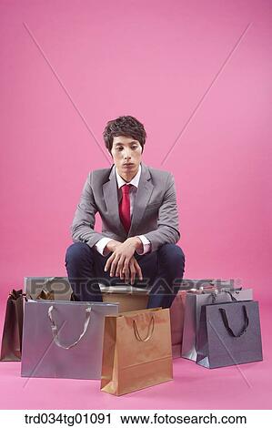 A man sitting around many shopping bags View Large Photo Image Stock Image - A man sitting around many shopping bags. Fotosearch