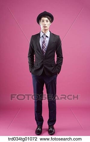 A man wearing black hat and suit with the pink background View Large Photo Image Stock Image - A man wearing black hat and suit with the pink background. Fotosearch