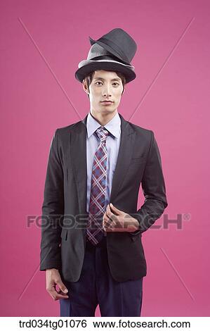 A man wearing black suit with various colors of hats on his head View Large Photo Image Stock Photograph - A man wearing black suit with various colors of hats on his head. Fotosearch