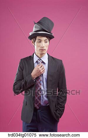 A man wearing black suit with various colors of hats on his head View Large Photo Image Stock Photography - A man wearing black suit with various colors of hats on his head. Fotosearch