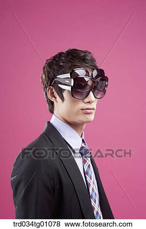 A man wearing many sunglasses on his eyes View Large Photo Image Stock Photo - A man wearing many sunglasses on his eyes. Fotosearch